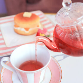 ホットケーキとピンクのカップアンドソーサーに注がれた紅茶